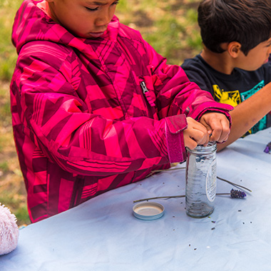 Two boys makig some potions outdoors