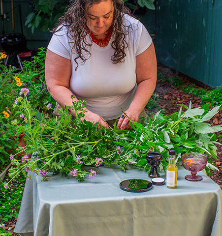Hand-gathered bundle of fresh sage and herbs.
